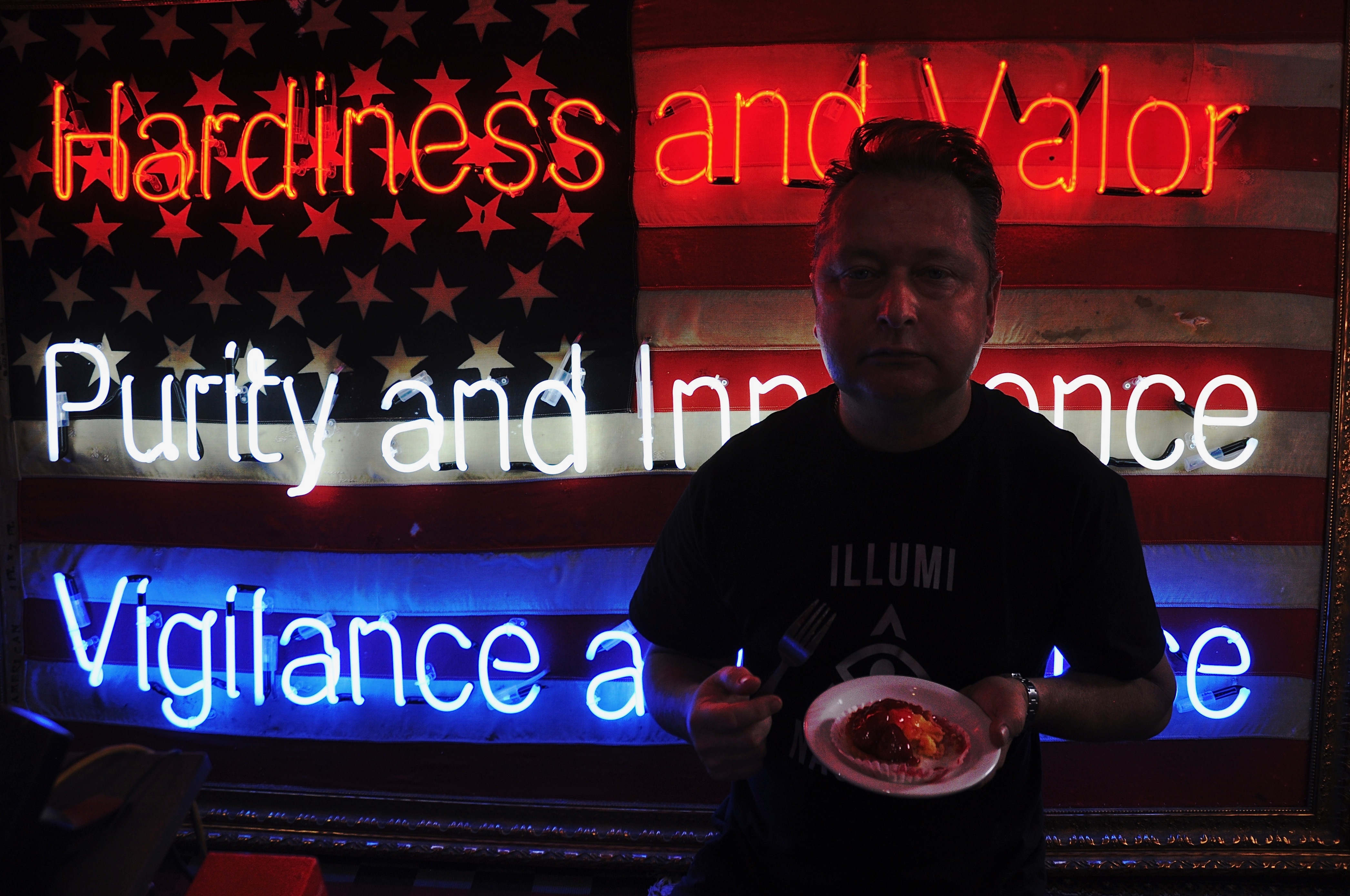 Portrait of artist mark Sloper with his work in CAKE